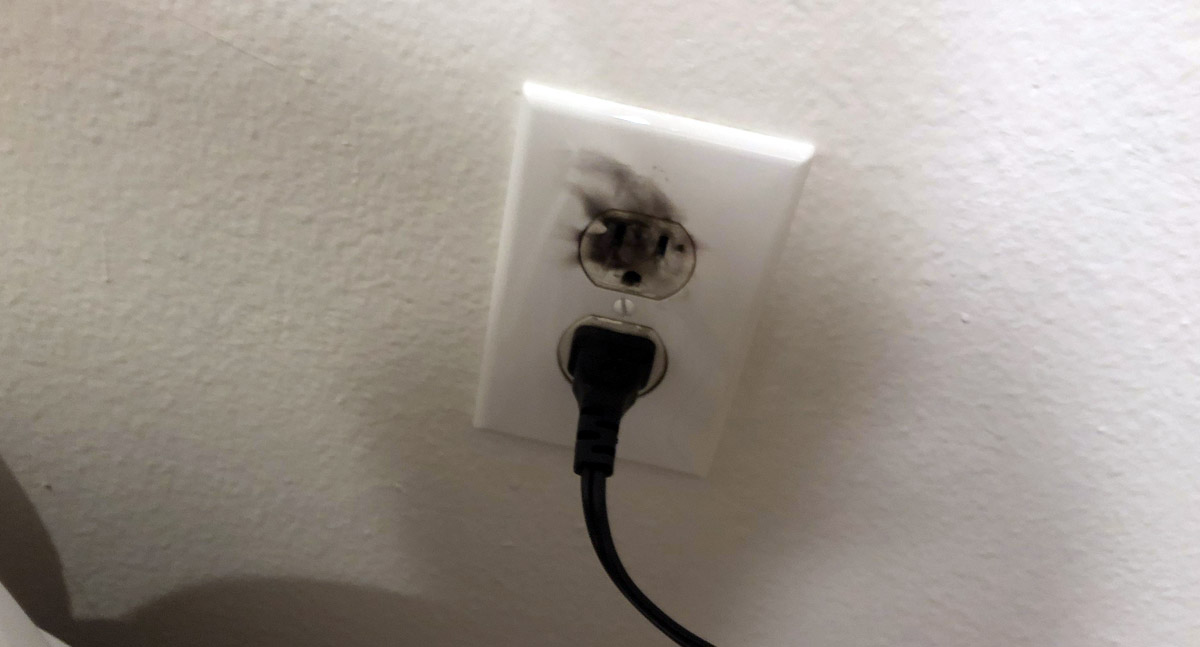 Sparks coming from an electrical wall outlet